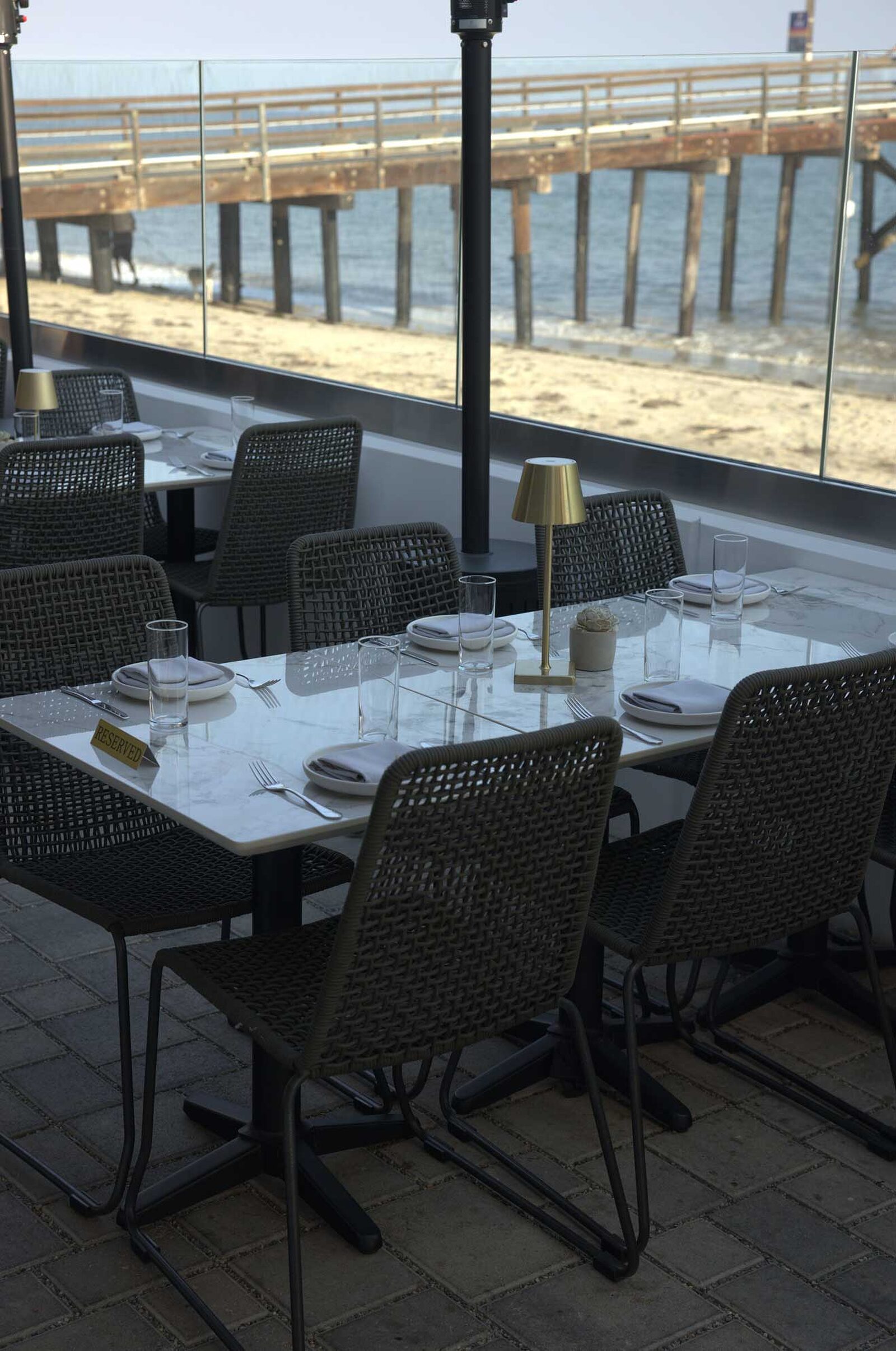 The Ellwood dining room, patio and plates by the ocean