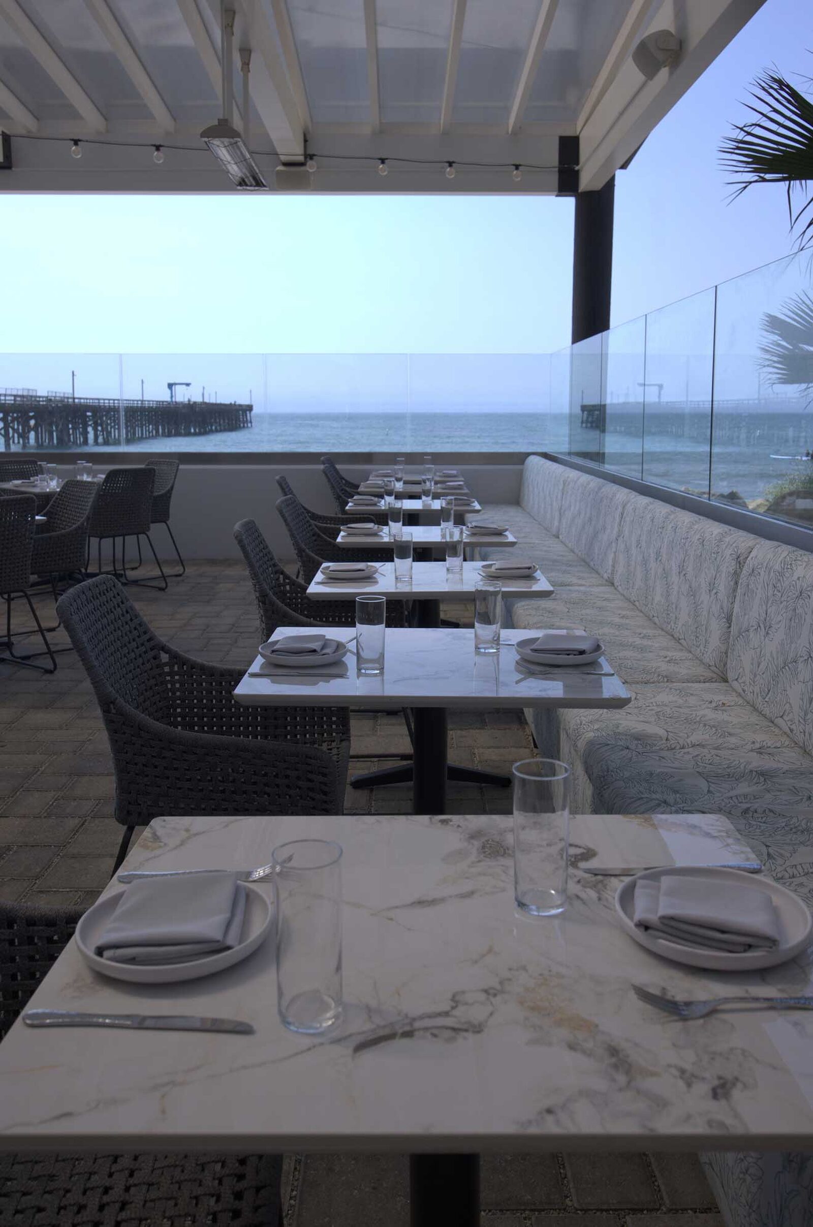 The Ellwood dining room, patio and plates by the ocean