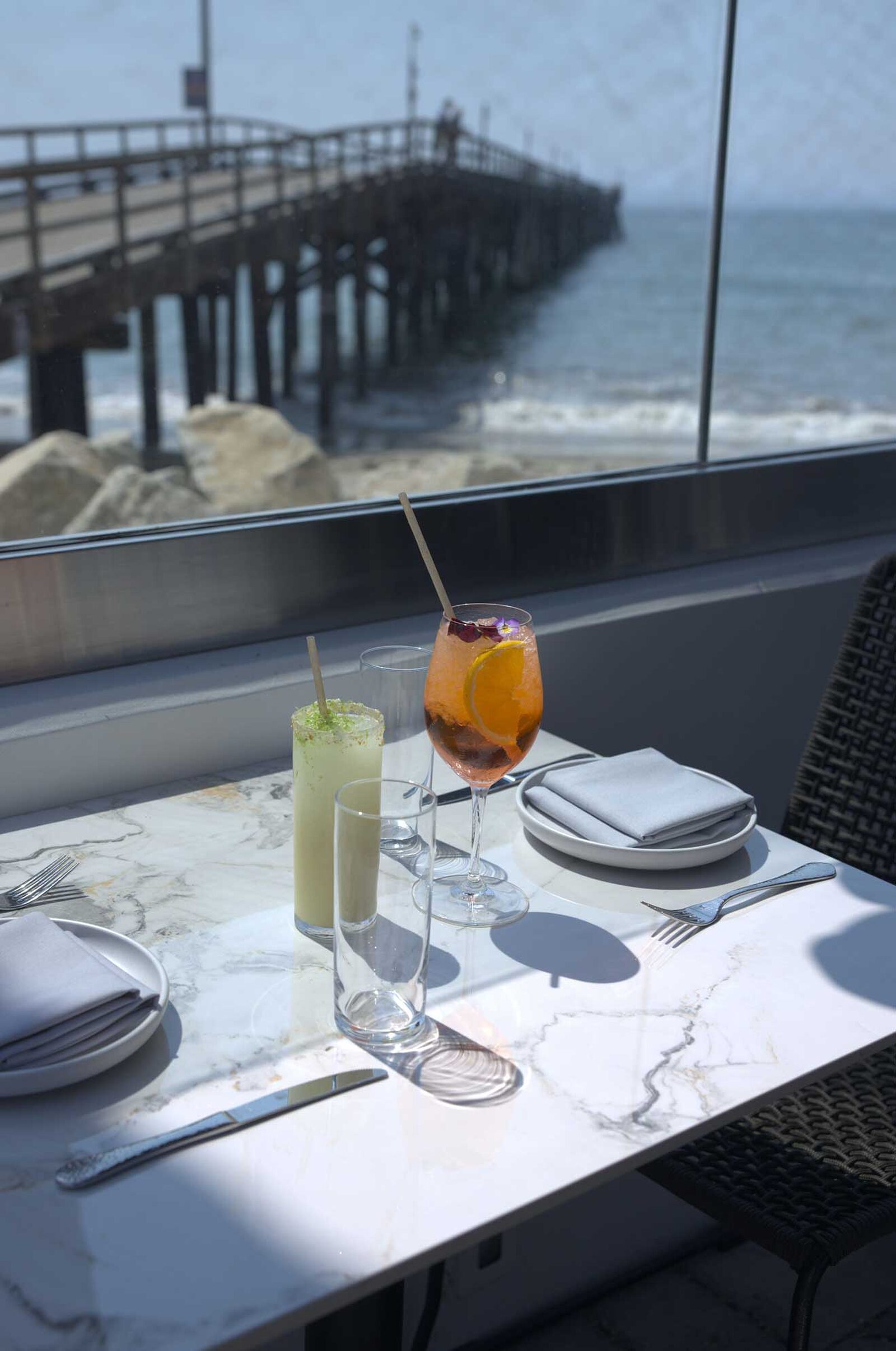 The Ellwood dining room, patio and plates by the ocean