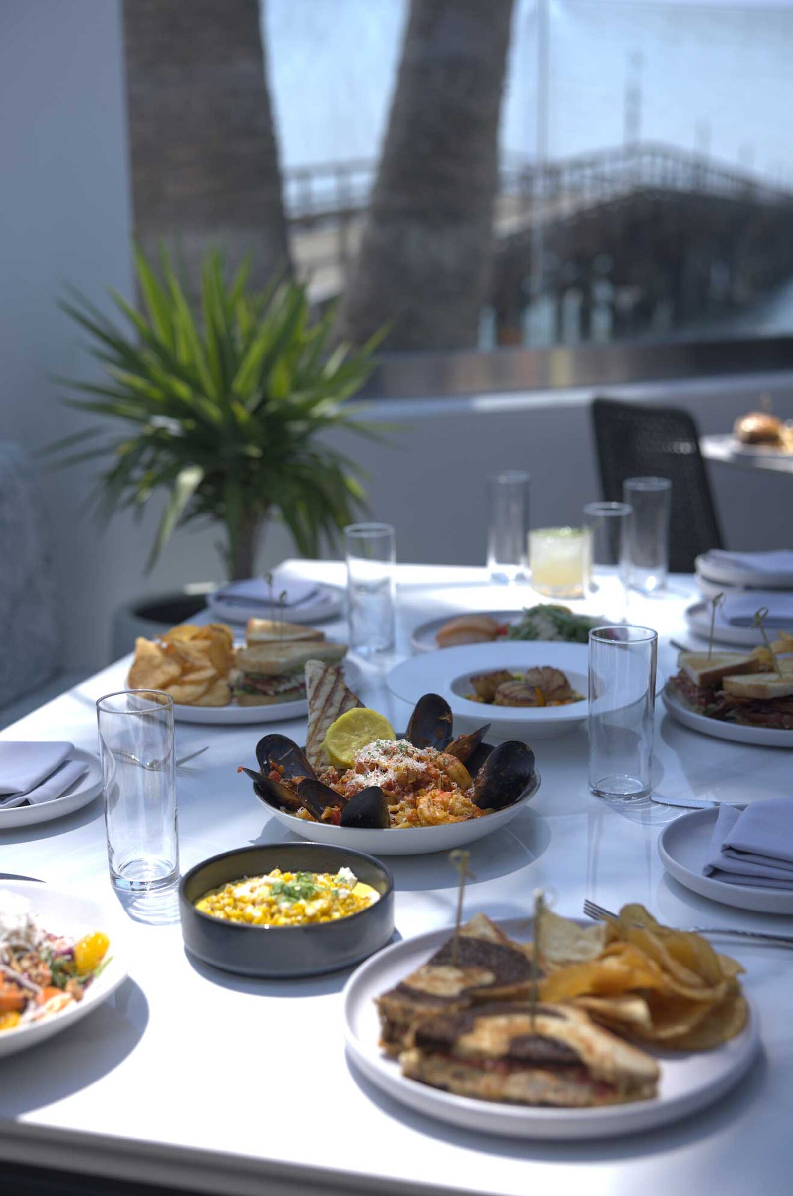 The Ellwood dining room, patio and plates by the ocean