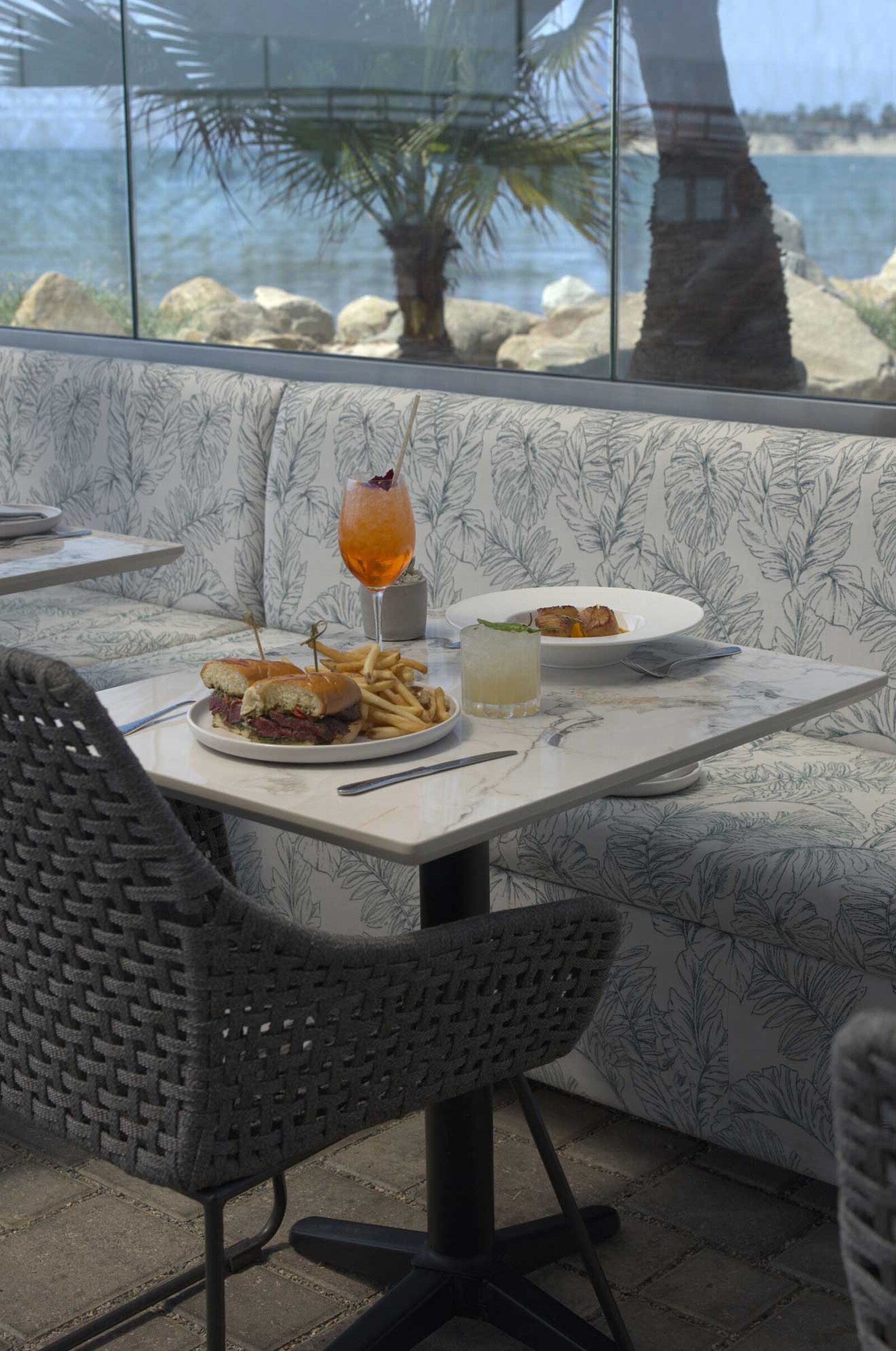 The Ellwood dining room, patio and plates by the ocean