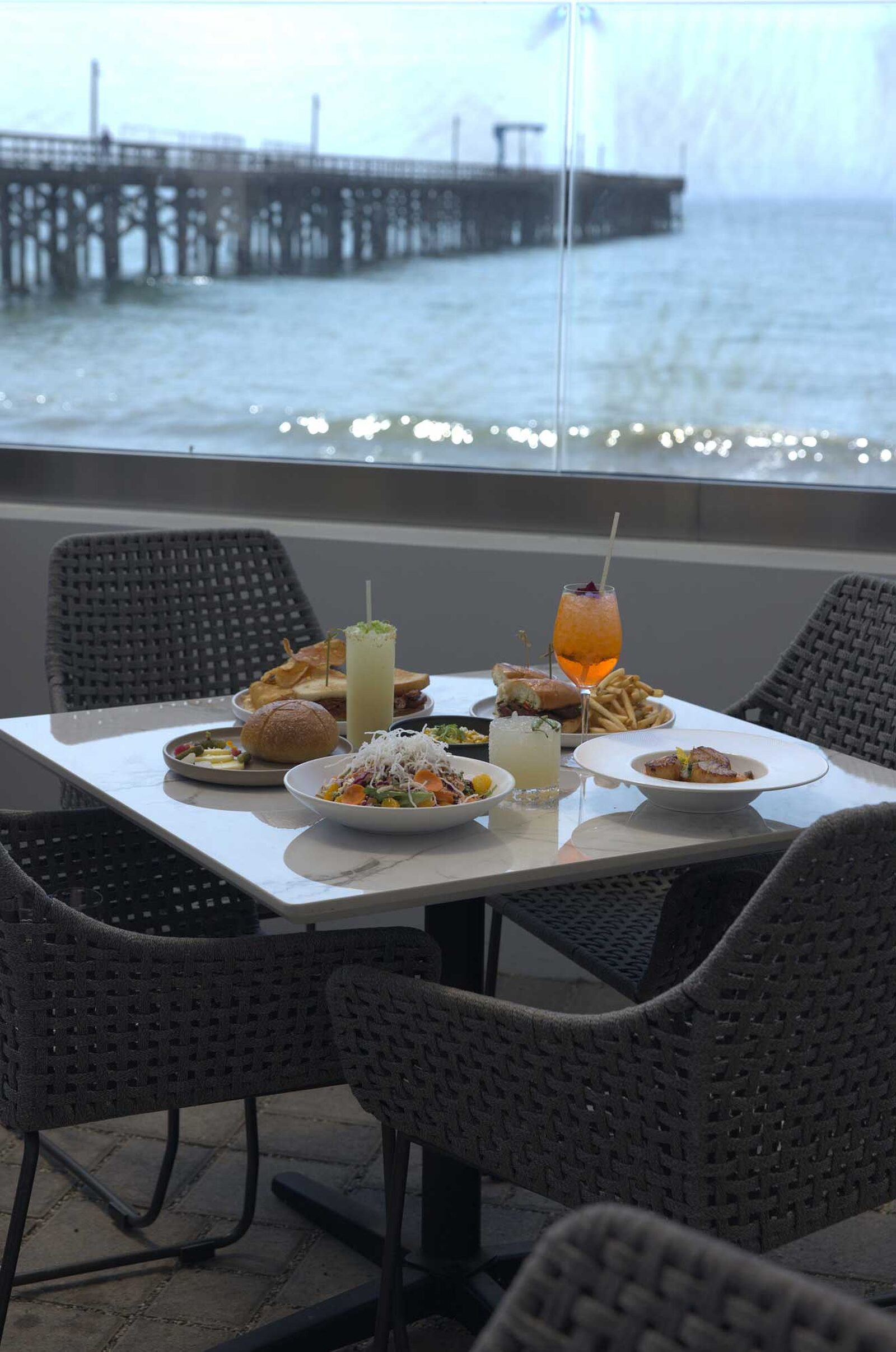 The Ellwood dining room, patio and plates by the ocean